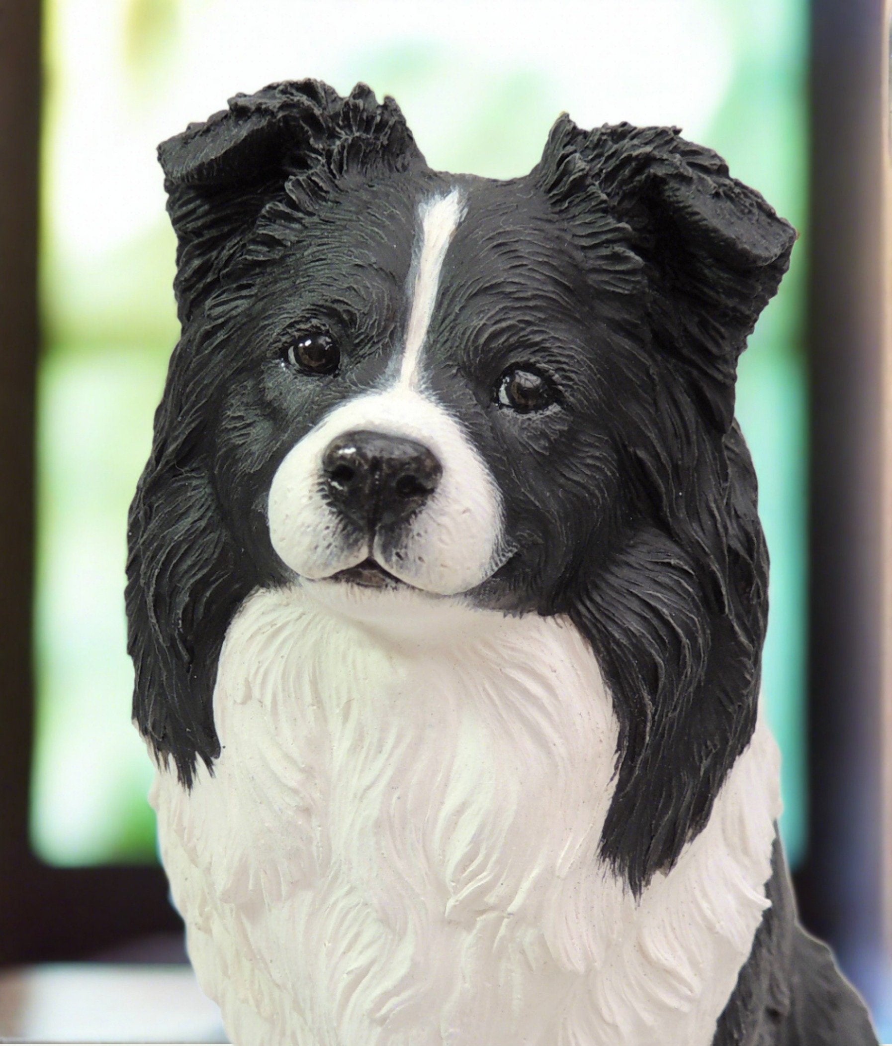 Sculpture of a black and white border collie